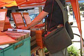 Vinyl record collector using his BackTpack for finding vinyl records at a Flea Market