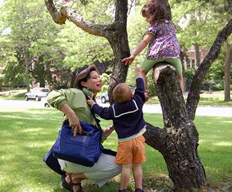 Mother caring for her children's safety while wearing BackTpack