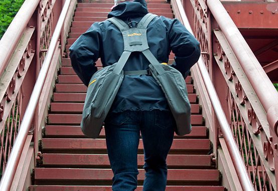 Man climbing long flight of stairs with ease wearing backTpack