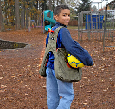 BTP3 worn by boy in schoolyard holding a soccer ball